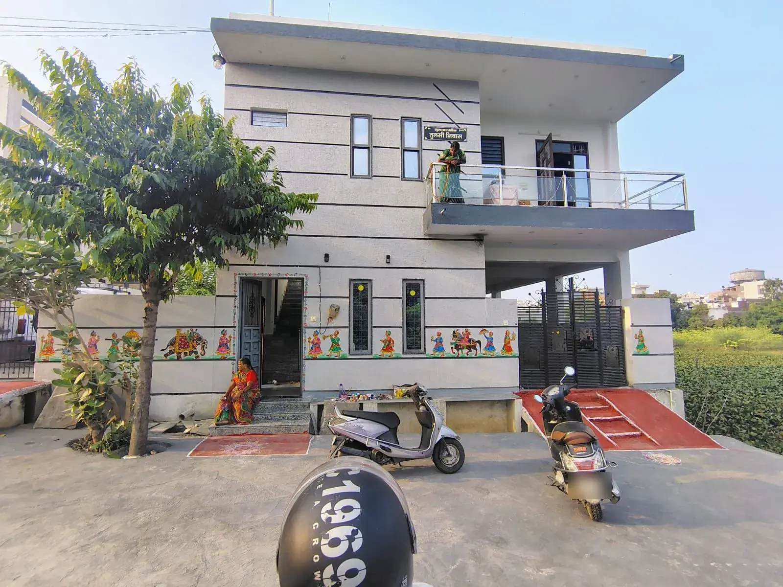 Completed G+1 house built in Udaipur with textured grey elevation and glass balcony railing