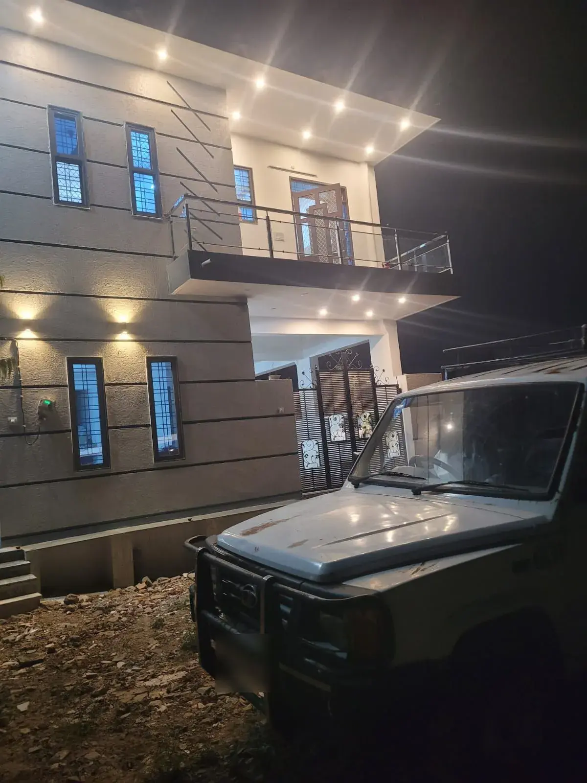 Night view of the house elevation with recessed LED ceiling lights and wall-wash lights